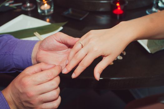 Joyful man making proposal to his future wife.