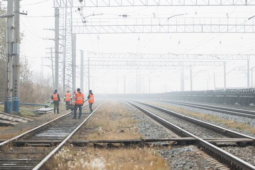 Railroad workers maintaing railways. checking construction