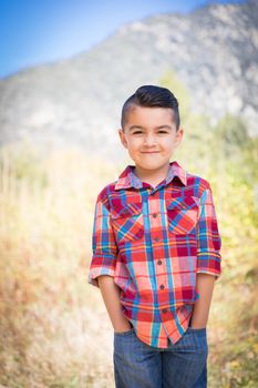 Mixed Race Young Boy Standing Outdoors.