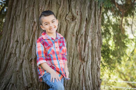 Mixed Race Young Boy Standing Outdoors.