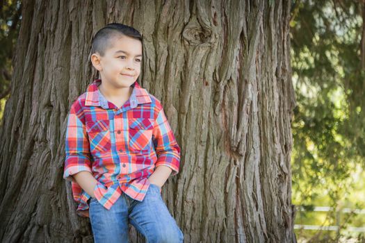 Mixed Race Young Boy Standing Outdoors.