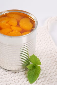 can of peeled tangerines on white table mat