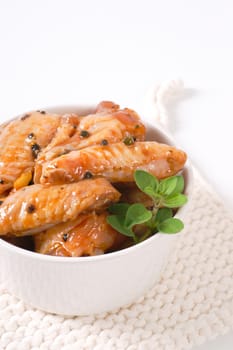 bowl of marinated chicken wings on white table mat