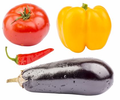Fresh vegetables on the white background. Tomato, two peppers and eggplant