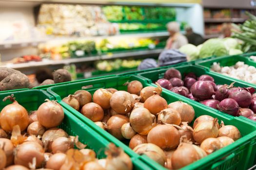 Onions on supermarket vegetable shelf