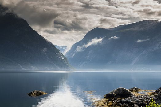 reflection of mountains and nature in eidfjord norway