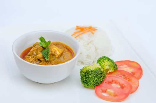 chicken tikka masala served with rice and vegetables