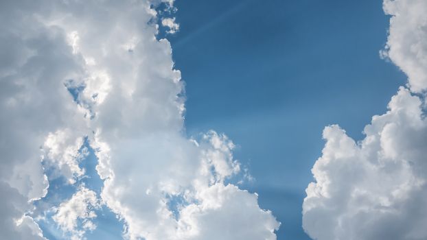 White fluffy clouds on a blue sky background