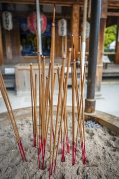 incense sticks in Kinkaku-ji golden temple, Kyoto, Japan