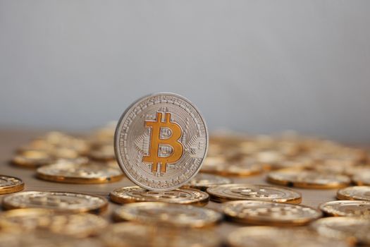 Digital currency physical bitcoin coin. Gold background coins concept.