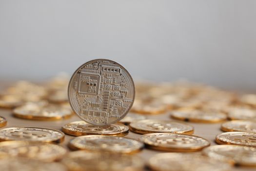Digital currency physical bitcoin coin. Gold background coins concept.