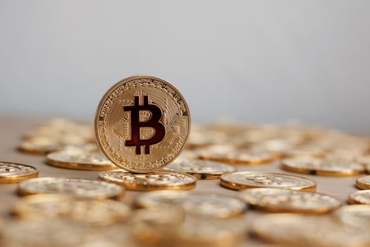 Digital currency physical bitcoin coin. Gold background coins concept.