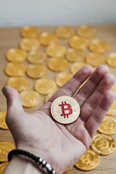Digital currency physical bitcoin coin. Gold background coins concept.