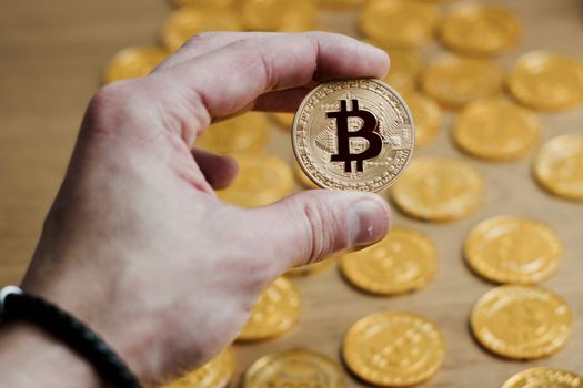 Digital currency physical bitcoin coin. Gold background coins concept.