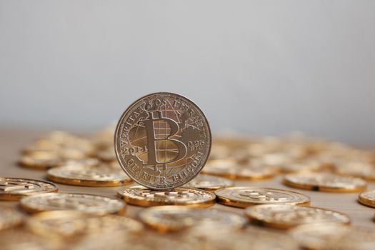 Digital currency physical bitcoin coin. Gold background coins concept.