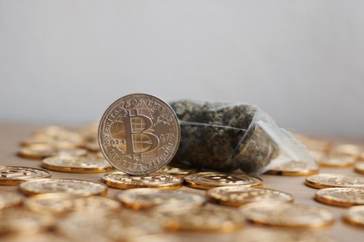 Digital currency physical bitcoin coin. Gold background coins concept.