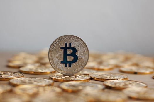 Digital currency physical bitcoin coin. Gold background coins concept.