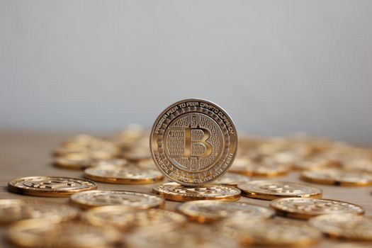 Digital currency physical bitcoin coin. Gold background coins concept.