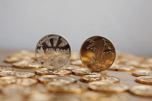 Digital currency physical bitcoin coin. Gold background coins concept.