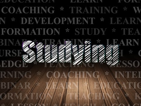Education concept: Glowing text Studying in grunge dark room with Wooden Floor, black background with  Tag Cloud