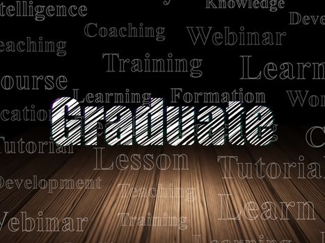Studying concept: Glowing text Graduate in grunge dark room with Wooden Floor, black background with  Tag Cloud