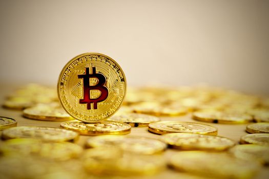 Digital currency physical bitcoin coin. Gold background coins concept.
