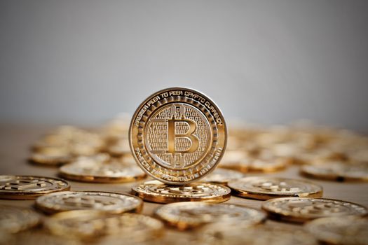 Digital currency physical bitcoin coin. Gold background coins concept.
