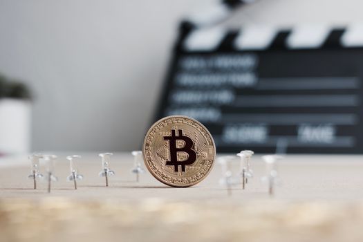 Digital currency physical metal bitcoin coin. Cryptocurrency cinema concept.