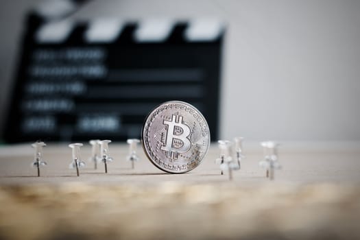 Digital currency physical metal bitcoin coin. Cryptocurrency cinema concept.