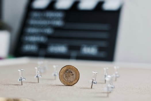 Cinema lifestyle concept. One pound sterling metal coin.