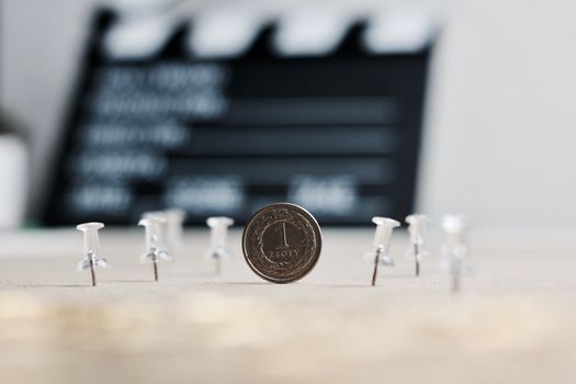 Physical polish coin near cinema board. Polish money lifestyle concept.