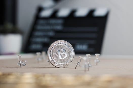 Digital currency physical metal bitcoin coin. Cryptocurrency cinema concept.