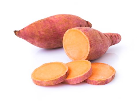 Sweet potato with slices on white background, raw food