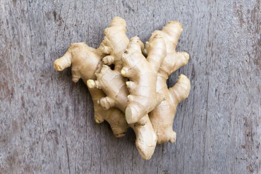 Closeup ginger roots with wood background