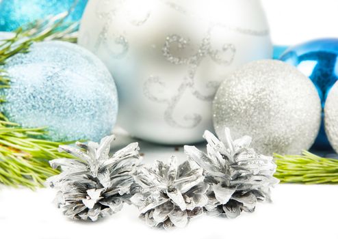 Fir tree branch and three cones on white background