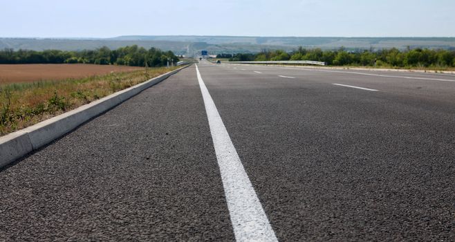 new asphalt road for fast driving at summer
