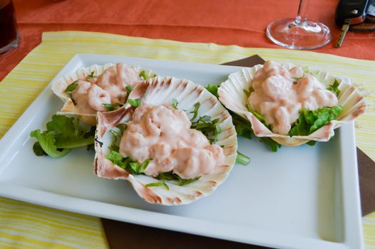 Cocktail of pink shrimp served in scallops in the dolomites in Italy