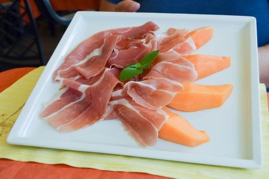 Plate of melon and Parma ham served in Italy