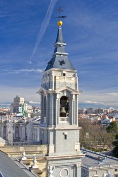 Bell tower of Santa Maria la Real de La Almudena cathedral with Madrid city on background, Spain