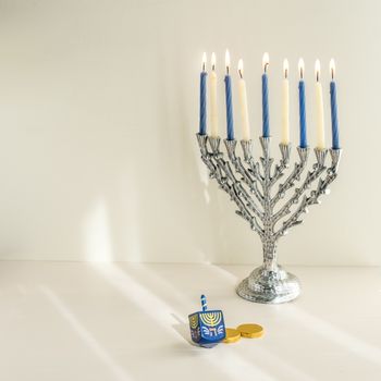 The Symbols of Hanukkah - nine-branched mehorah Hanukiah , chocolate coins and sevivon