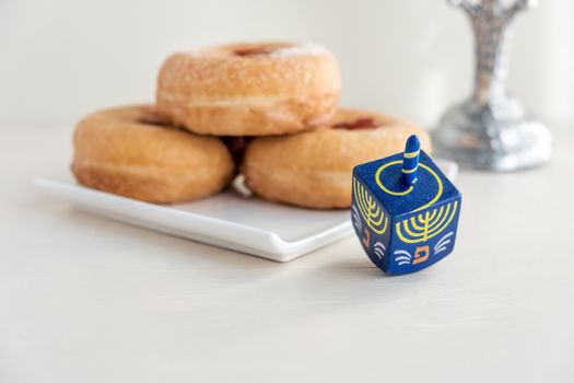 The Symbols of Hanukkah - nine-branched mehorah Hanukiah , sufganiyot and sevivon