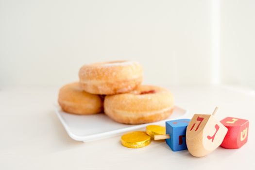 The Symbols of Hanukkah - sufganiyot, chocolate coins and sevivon