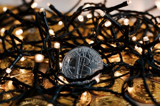 Digital currency physical metal bitcoin coin on the christmas concept.