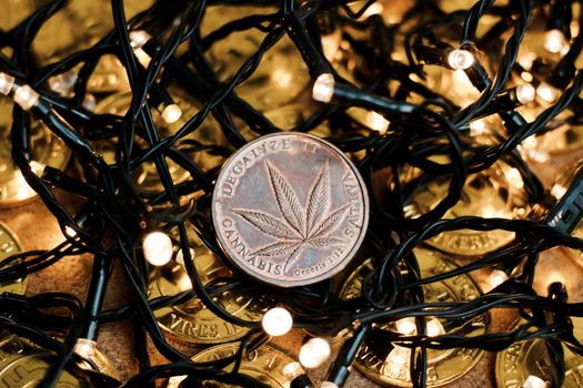 Brass physical marijuana coin. Christmas time sativa concept.