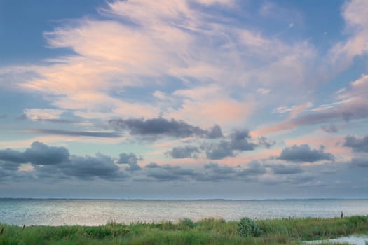 Sandy empty sea coastal seaview, cloudy colourful sunrise sky view