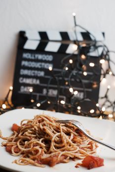 Italian tasty pasta with tomatoes on a silver fork. Christmas concept.