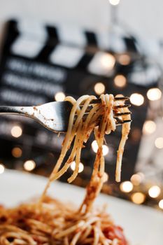 Italian tasty pasta with tomatoes on a silver fork. Christmas concept.