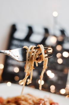 Italian tasty pasta with tomatoes on a silver fork. Christmas concept.