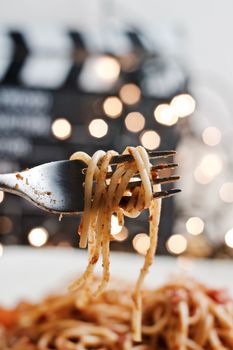 Italian tasty pasta with tomatoes on a silver fork. Christmas concept.