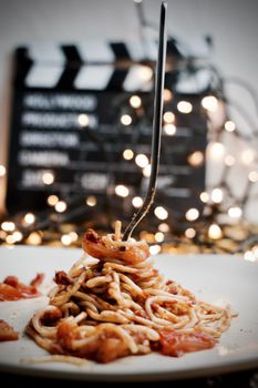 Italian tasty pasta with tomatoes on a silver fork. Christmas concept.